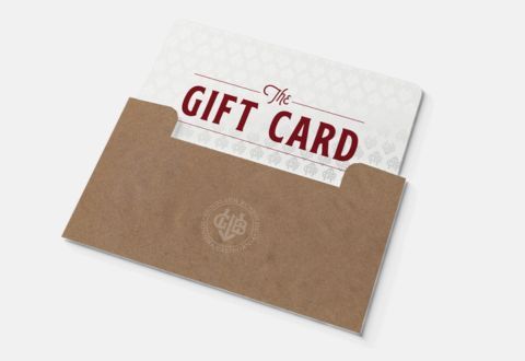 white gift card with red text in a brown envelope